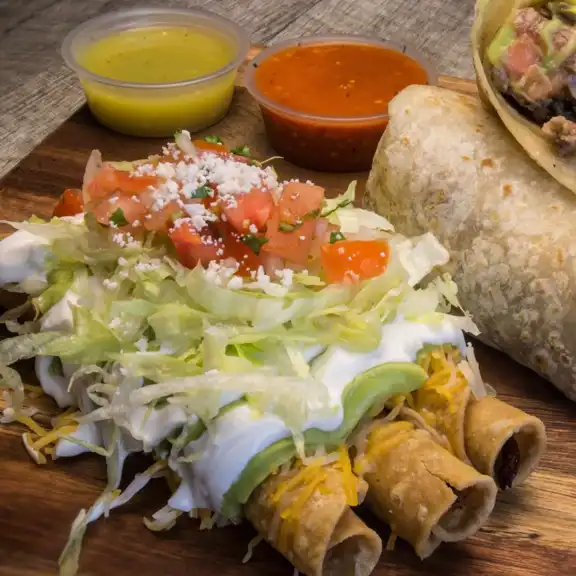 Crispy rolled taquitos topped with lettuce, sour cream, cheese and pico de gallo