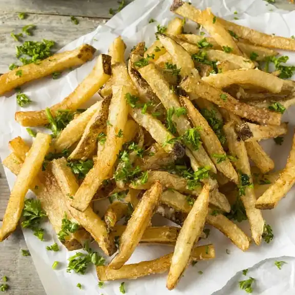 Crispy seasoned french fries garnished with fresh parsley